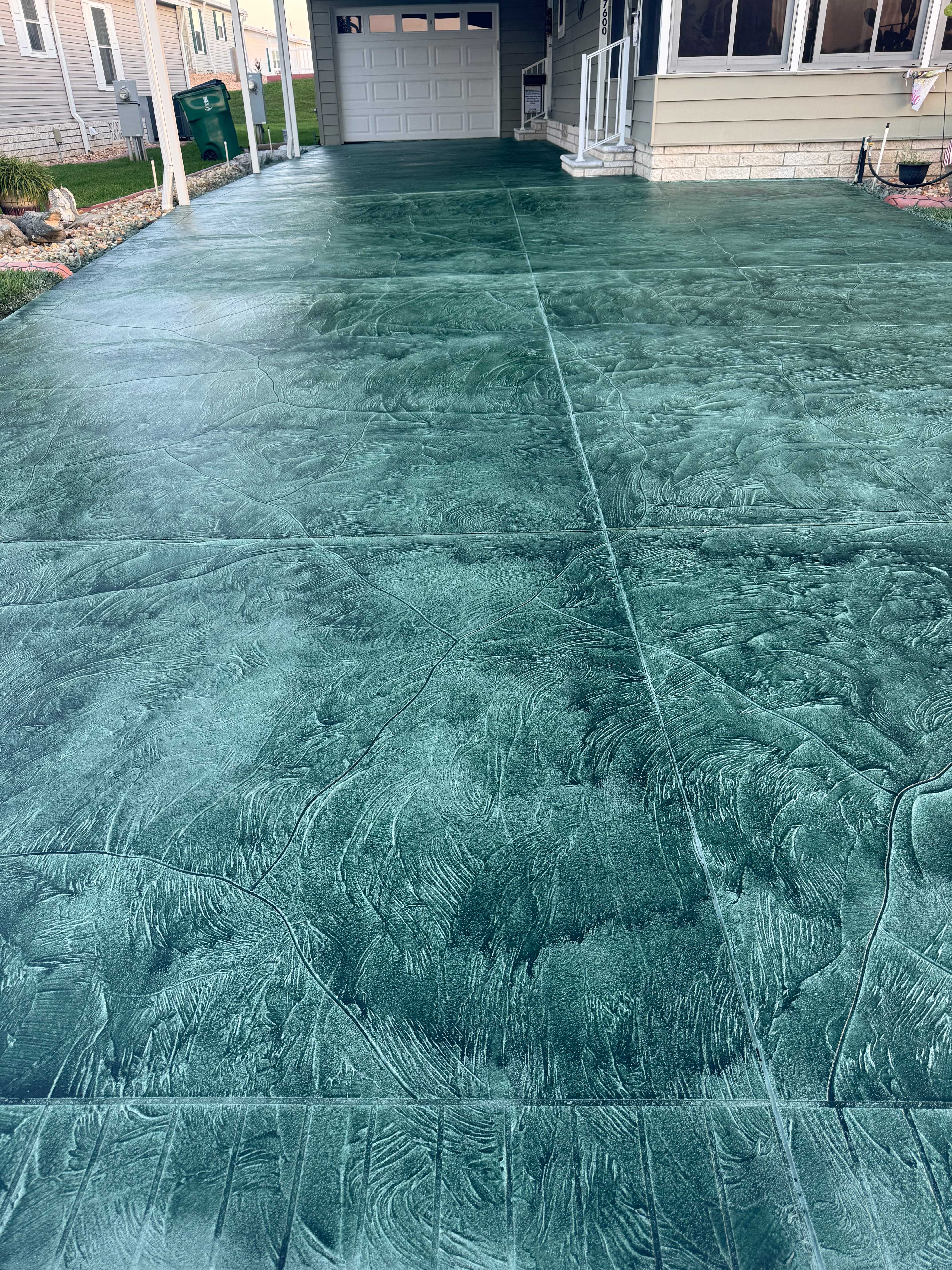 Concrete resurfacing transformation - decorative teal driveway